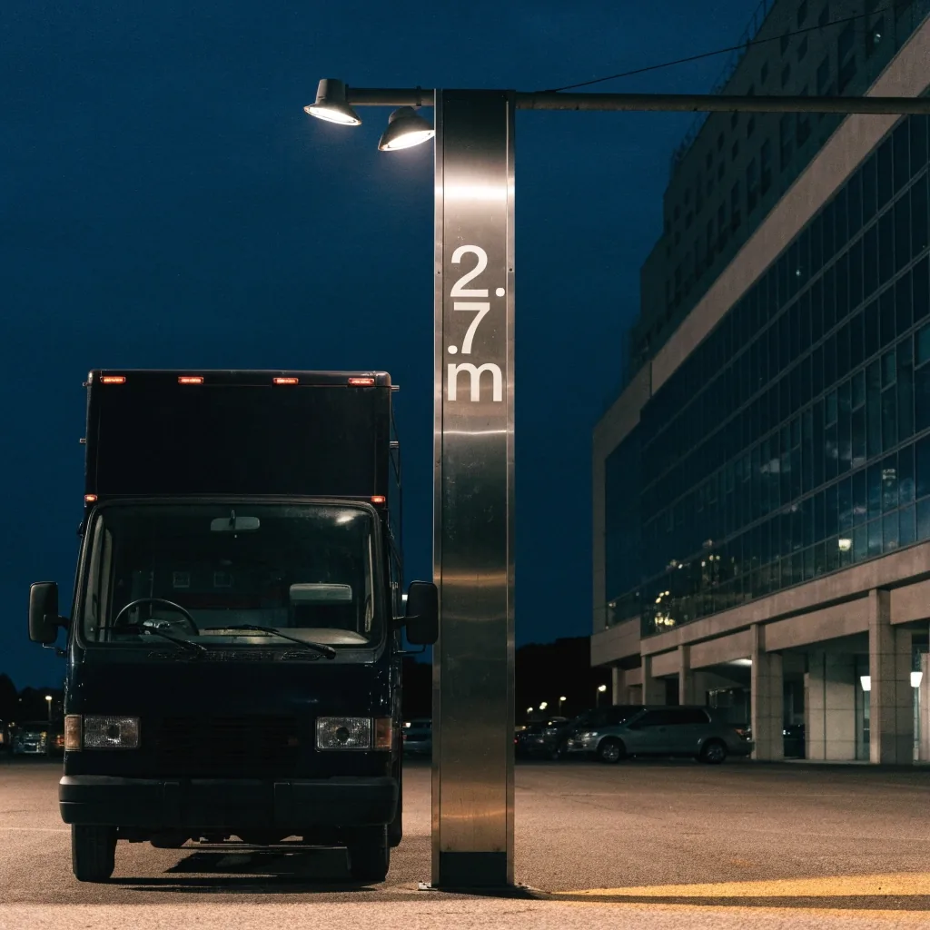 Tall vehicle under a height gantry at Brisbane Airport parking